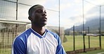 Soccer, player and training of man, fitness and serious for stretching, field and jumping for practice. Outdoor, breathing and black person with wellness, exercise and preparation for game and sports