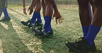 Football, team and legs with warm up for fitness on field with energy, exercise and workout for competition. Sport, endurance and training on grass pitch for soccer match, performance and tournament