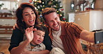 Christmas, video call and parents with child in home excited for holiday, vacation and festive celebration. Family, communication and mom, dad and kid on smartphone for talking, chat and bonding