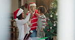 Happy family, child and ornaments on Christmas tree for festive, holiday and celebration in home. People, bonding and daughter with decorate, lights and living room as parents on vacation in December