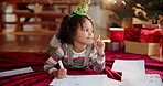 Christmas, child and thinking in home with paper, drawing and writing note to Santa. Young girl, idea and picture on floor for creativity, gift brainstorming and DIY greeting card for festive season