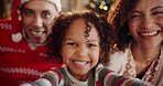 Selfie, child and parents with smile, Christmas and portrait of family, bonding or memory for holiday. Happy, woman and man with kid, photography and mother with girl, joy and father with hat or home