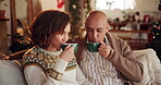 Home, couple and smile with coffee  on couch at living room for bonding and support on Christmas. People, relationship and happy on sofa in lounge with cup of tea to relax on festive season or break