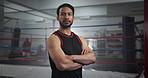 Crossed arms, sports and face of man boxer in gym for competition practice, match or workout for conditioning. Serious, confident and portrait of fighting champion from Mexico for fitness training.