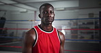 Serious sports and face of black man boxer in gym for competition practice, match or workout for conditioning. Pride, confident and portrait of fighting champion from Nigeria for fitness training.