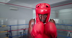 Boxing, punch and black man in gym with helmet, energy and champion athlete training for competition. Gloves, hit and speed boxer in ring with fitness, exercise or workout challenge at fight club