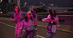 Dancing, night and people on bridge in city with hip hop routine practicing for battle. Energy, neon lights and dancers with freestyle, groove or choreography in street with rhythm in urban town.