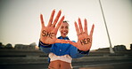 Happy, woman and hands with pronouns in city for gender identity, terminology and awareness. Female person, smile and face with word text on palm at sunset for she, her and preference information