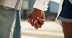 Couple, love and holding hands outdoor in city with romance, travel and bonding together. Closeup, people and support with trust, relationship and commitment with care, affection and loyalty on date