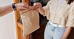 Hands, package and food delivery to customer at front door for ecommerce, shipping or logistics. Courier, woman and giving parcel in paper bag for order, takeaway or fast distribution service at home