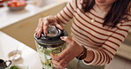 Hands, woman and smoothie in blender in kitchen for breakfast drink, healthy diet and close lid. Person, nutritionist and prepare ingredients in home for detox shake and nutrition lunch with top view