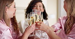 Cheers, champagne and bride with friends for wedding in hotel room with bonding for commitment ceremony. Happy, alcohol and woman with bridesmaids for celebration toast with sparkling wine for party.