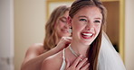 Happy woman, wedding dress and jewelry with necklace for marriage, commitment or support on big day at home. Young, female person or friends with smile for fashion, style or grooming before ceremony