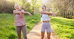 Exercise, park or stretching with mother and daughter outdoor in summer for cardio or marathon training. Fitness, runner or workout with mature parent and woman in forest for start of warm up routine