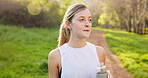 Woman, fatigue and drinking water in nature for fitness, drink and hydration with break, electrolytes and health. Female person, bottle and thirsty outdoor for exercise, workout and morning with run