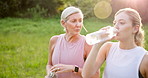 Drinking water, exercise or park with mother and daughter outdoor in summer for cardio or marathon training. Conversation, fitness or walking with mature parent and woman in forest for workout