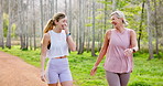 Mature mother, daughter and forest with walking for fitness, exercise and workout in Canada. Family, people and happy or smile with funny conversation for bonding, support and care in park for health