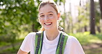 Girl, laughing and hiking with backpack in forest with funny adventure, sightseeing and exploring nature. Person, portrait and happy in woods with trekking, cardio fitness and travel on trail path