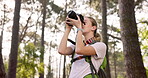 Travel, explore and woman with camera in nature for environment, photography and outdoor adventure. Summer, journey and photographer with picture in forest for backpacking, sightseeing and memory