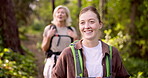 Mother, daughter and hiking with walking in forest for fitness adventure, backpack or sightseeing in nature. Mature woman, girl and trekking in woods for cardio exercise, explore environment or happy