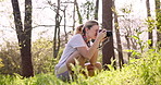 Woman, photographer and hiker with camera in forest for sightseeing, inspiration or tourism. Young, female person or traveler with technology or lens for picture, photography or memory in nature