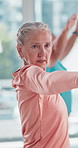 Elderly woman, exercise and yoga in class at gym healthy body, workout and fitness in retirement. Female person, yogi and warrior pose at health club for wellness, support and balance in morning