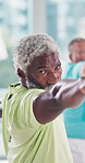 Elderly man, exercise and yoga in class at gym healthy body, workout or wellness in retirement. Male person, yogi and serious in warrior pose at health club for fitness, support or balance in morning