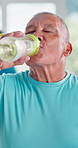 Senior man, drinking water and bottle at gym with face, training and smile on break for fitness. Elderly person, liquid and happy for wellness, detox and gut health in morning at class in Colombia