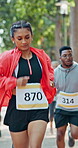 Running, fitness and woman in marathon in nature with group for outdoor exercise or competition. Sports, energy and female athlete with cardio workout in race with crowd for contest in park.