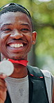 Medal, winner and face of black man at race in nature with pride for fitness goal or achievement. Happy, excited and portrait of African male athlete with gold award for marathon with cardio exercise