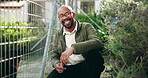 Face, black man and shelter for animal adoption with volunteer service, homeless dogs and rescue centre. Smile, male person and relax by fence with safety, foster care and pet welfare for charity ngo