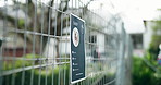 Animal shelter, fence and poster of rescue dog outdoor for adoption, community or pet ownership. Cage, charity and sign with information on enclosure at pound for activism, attention or welfare