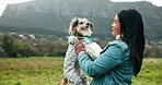 Woman, dog and playing with puppy in nature for bonding, morning walk and comfort with security. Animal rescue, volunteer or companion pet for training, exercise or happy for loyalty in outdoor field