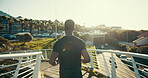 Running, morning and back of man in city for training, health and cardio endurance. Marathon, exercise and fitness workout with person on urban bridge for wellness, energy and sports athlete