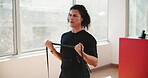 Woman, gym and strength with band training or stretching for fitness, exercise and workout. Female person, muscle building and biceps with strength for health, self care and wellbeing in sportswear