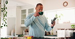 Man, drinking coffee and phone in home for social media, text message and contact. Mature person, tea and mobile in kitchen for connectivity, communication and research beverage benefits for interest