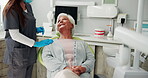 Dentist, talking and checkup for mature woman, consultation and healthcare for senior person and smile. Hospital, teeth and oral hygiene for grandma, medical appointment and treatment for toothache