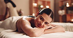 Happy woman, relax and massage with bed for zen, physical therapy or treatment at luxury spa or resort. Portrait, young or female person with smile in comfort for relaxation or stress relief at salon