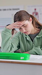 Student, stress and writing exam with education, thinking and anxiety in classroom for scholarship. Female person, headache and high school in learning, development and academy for study or research