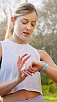 Woman, exercise and smart watch in nature for workout, information and progress of training. Digital, check and person with technology in forest for heart rate tracker, monitoring and fitness app