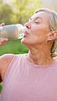 Mature woman, drinking water and hydration on walk or run for fitness, wellness and exercise as athlete. Female person, health and outdoor activity with care for workout, break and rest in nature