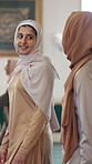 Muslim women, walking and talking with hijab in mosque for faith, belief or islamic community at holy temple. Arab, female people or friends with scarf for salah, praying or group in praise together