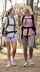 Outdoor, backpacking and woman with senior mother in forest for exploring, adventure or trekking. Bonding, walking and female person with elderly mom hiking in woods in nature for exercise together.