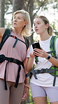 Woman, daughter and hiking in forest with phone for map, 
internet navigation and talk for travel direction. Mature mother, girl and smartphone in woods for path research, location or trekking break