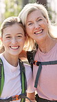 Woman, daughter and hiking in forest with hug and face portrait and summer adventure. Mature mother, girl and holiday in woods for path location, trekking break and bonding in retirement vacation