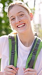 Happy, backpacking and face of woman in nature for fitness, adventure or exploring on vacation. Smile, trekking and portrait of female person from Switzerland hiking outdoor in forest or woods.