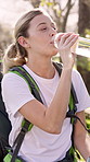 Outdoor, drinking water and woman with fitness, nature and wellness with health. Energy, runner and athlete in park, liquid and nutrition with challenge, exhausted and workout with balance or smile