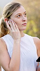 Woman, earphones and mobile phone on walk or run for fitness, wellness and exercise as athlete. Female person, technology and outdoor activity with music, podcast or streaming for workout in nature