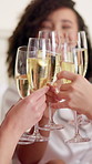 Cheers, champagne and bride with friends in hotel for getting ready for marriage ceremony. Happy, alcohol drink and woman with bridesmaids with sparkling wine for toast at wedding location together.