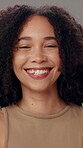 Woman, face and happy in studio for beauty, natural hair and confidence with healthy skin texture. Female person, portrait and laughing on gray background for self care, glow and organic curly afro